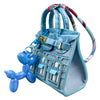 Light blue handcrafted mini house-shaped bag with a puppy keychain charm and colorful patterned strap