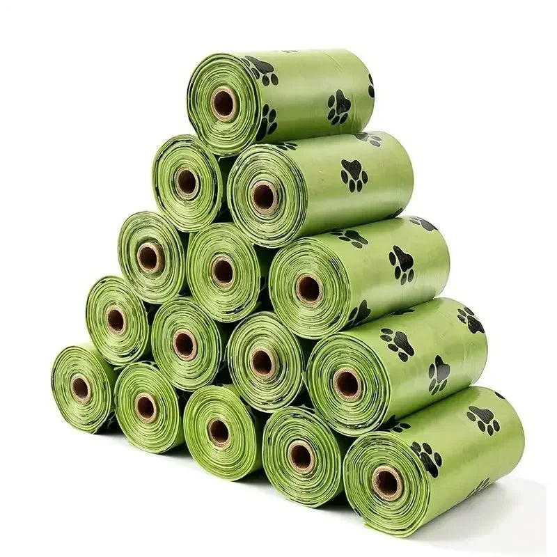 A stack of fifteen rolls of heavy duty dog poop bags in a light green color.