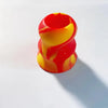A stack of silicone bat grip knobs in red and yellow swirling patterns.
