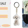 A small, fluffy white dog-shaped keychain pendant attached to a metal ring.