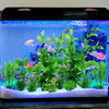 A vibrant green artificial water grass plant display in an aquarium tank with colorful fish.