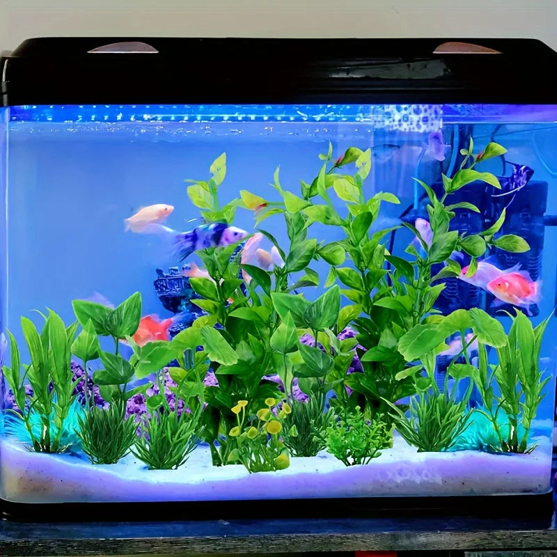 A vibrant green artificial water grass plant display in an aquarium tank with colorful fish.