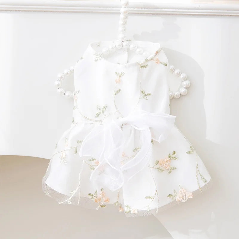 White summer dress for a dog featuring a bow and butterfly skirt with delicate floral embroidery