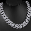 A close-up of a silver-toned Cuban link necklace with a curved flip buckle design displayed on a black display stand.