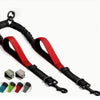 Black and red dual dog leash coupler with padded handles and shock-absorbing bungee.