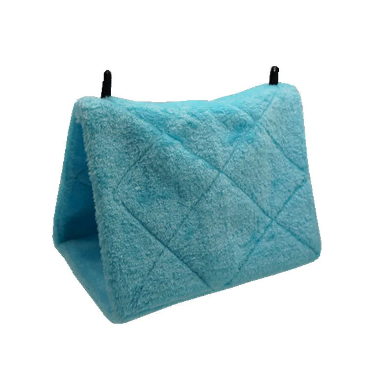 A teal blue plush bird hammock tent with a quilted texture and black hanging loops.