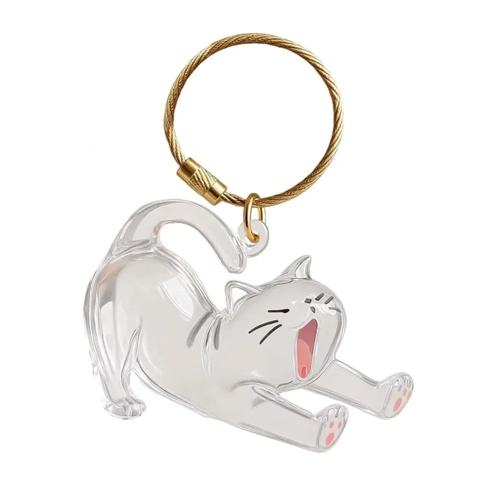 A clear, stylized cat figurine attached to a gold-colored keyring.