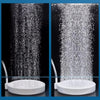Close-up view of an aquarium air stone disc diffuser creating a fine spray of water.