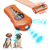 An orange paw-shaped ultrasonic dog repeller and bark control trainer device is shown with a hand and two dogs.