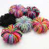 A collection of colorful elastic hair bands in various shades of pink, purple, blue, and black.