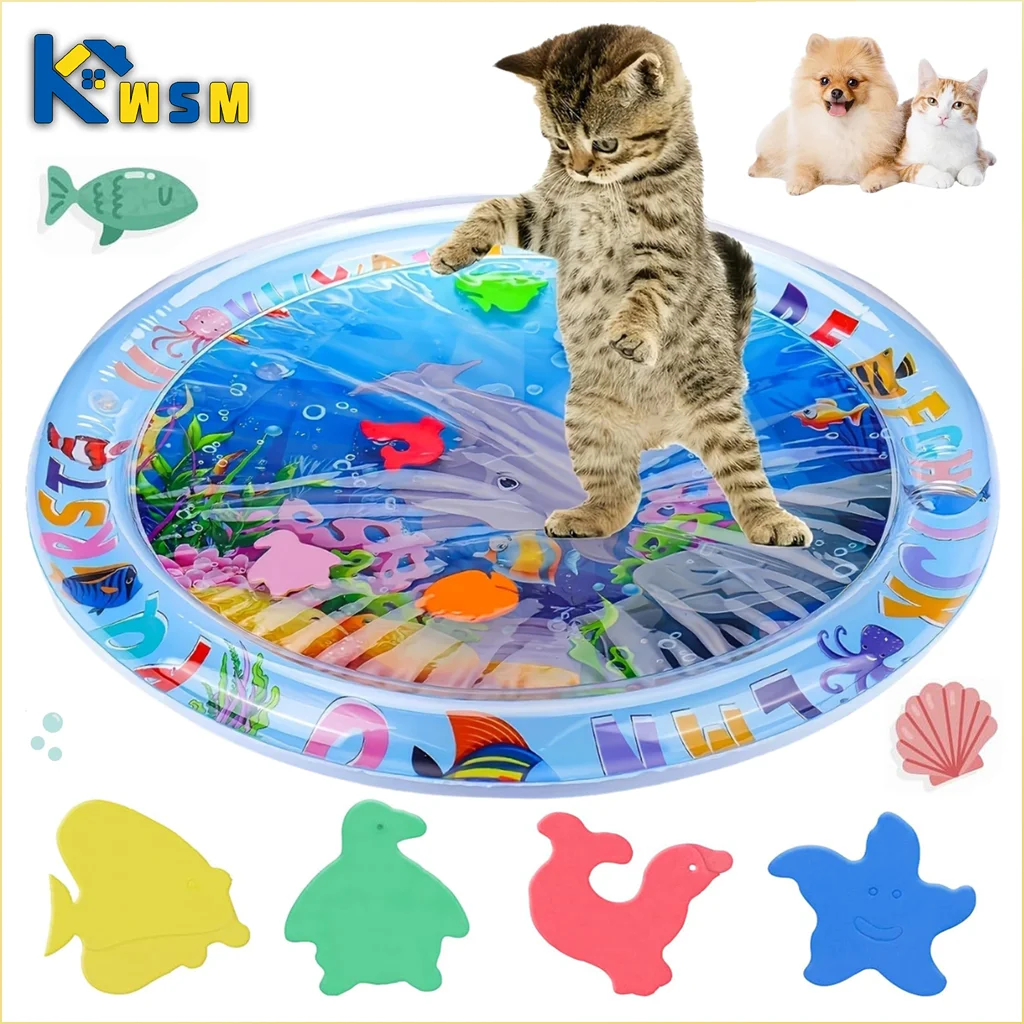 A gray tabby kitten stands on a blue plastic mat filled with colorful fish and sea creatures.