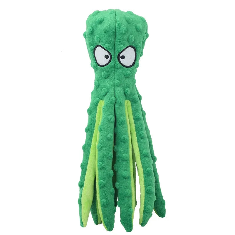 A bright green plush toy shaped like a monster with large white eyes.