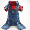 A plaid denim jumpsuit for a small dog, featuring red and black checks.