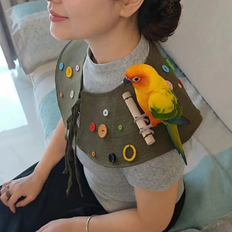 A woman is wearing a handmade coat decorated with colorful buttons and a yellow parrot perched on the shoulder.