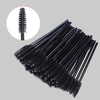 A set of disposable black eyelash and eyebrow brushes shown in a diagonal arrangement with an inset detail view.