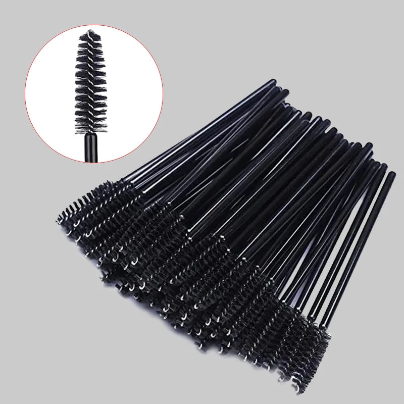 A set of disposable black eyelash and eyebrow brushes shown in a diagonal arrangement with an inset detail view.
