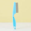 A light blue one-button pet hair removal brush with a wide comb is shown against a pale yellow background.