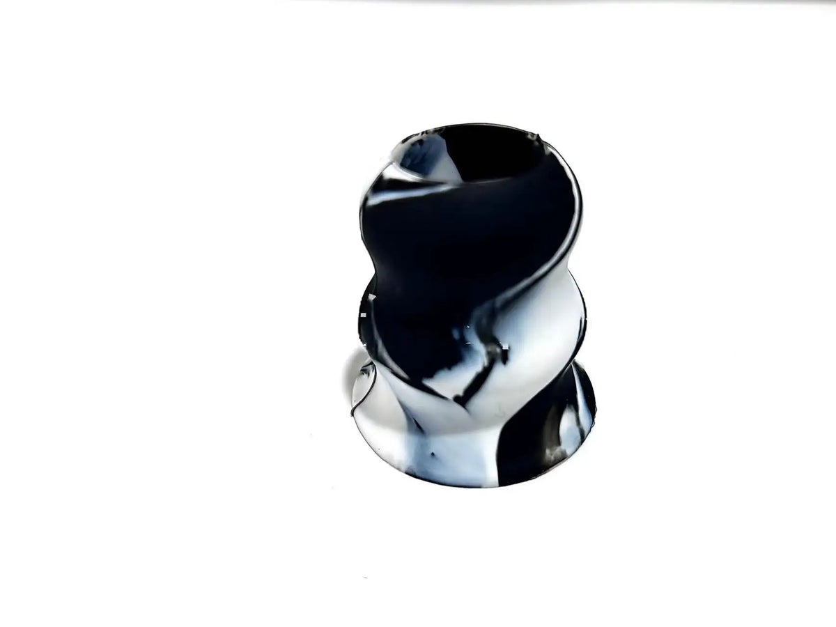A close-up view of a black silicone bat grip knob.