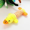 A yellow plush dog toy with orange stripes is shown next to a black and orange puppet.