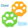 Two reusable pet hair and lint remover tools shaped like cat paws, one orange and one green.