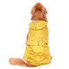 A golden retriever wearing a yellow reflective waterproof dog raincoat from the back view.