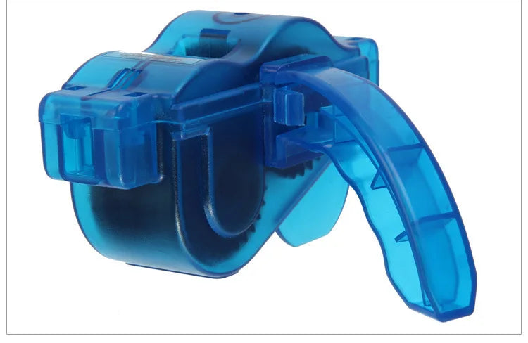 A bright blue bike chain cleaner tool featuring a plastic housing and an ergonomic brush system.