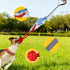 A dog is playing with an interactive tug of war rope toy, which features a dragon head design and is being pulled by a person