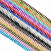 A close-up of a set of multi-colored plated ball bead necklaces arranged diagonally.