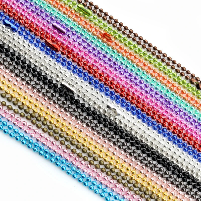 A close-up of a set of multi-colored plated ball bead necklaces arranged diagonally.