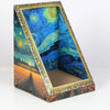A framed artwork depicting a vibrant night sky and landscape inside a rectangular box.