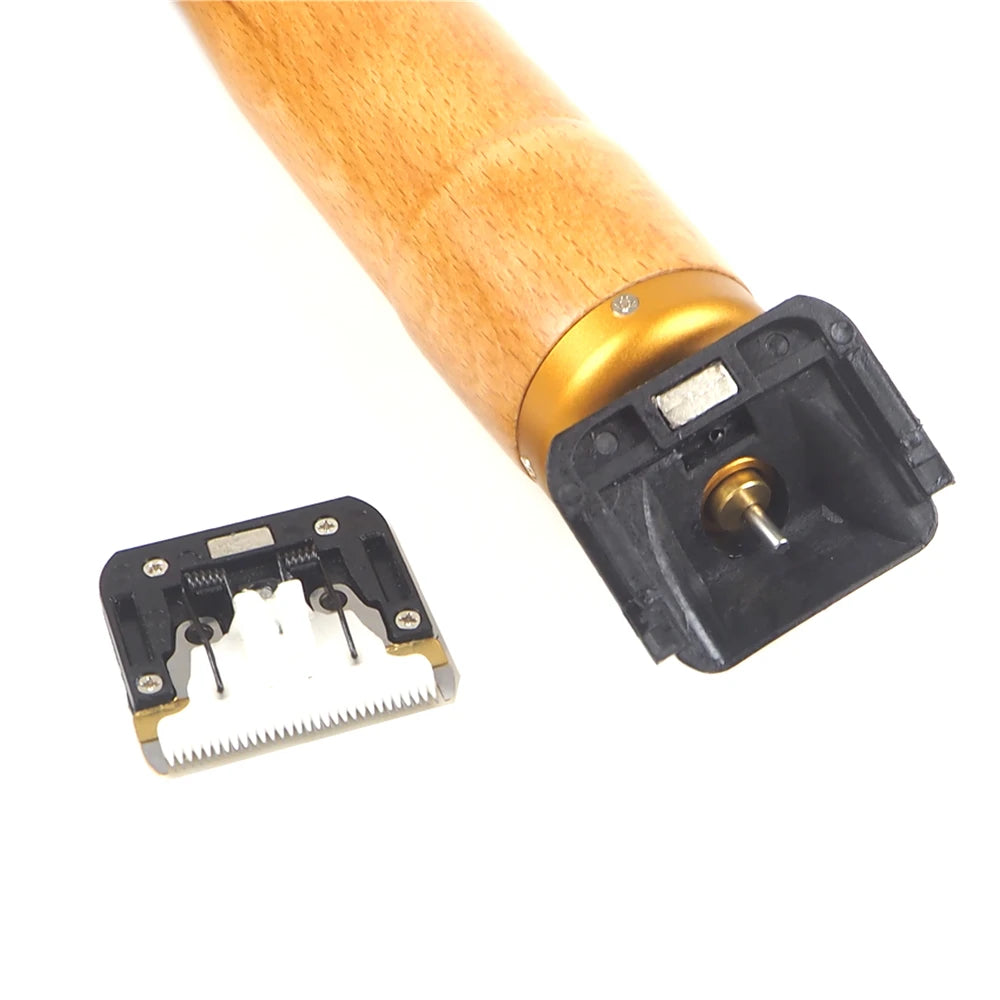 A close-up view of a wooden pet clipper with a black cutting head attached.