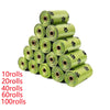 A stack of green biodegradable pet poop bags, varying in roll count from 10 to 100 rolls.