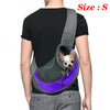A person is wearing a gray breathable dog sling carrier with a small dog inside, against a white background.