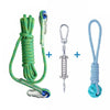 A green cotton rope dog spring pole toy with metal clasps and a blue braided cord.