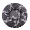 A round, gray plush pet bed with a removable washable cover featuring a striped pattern.