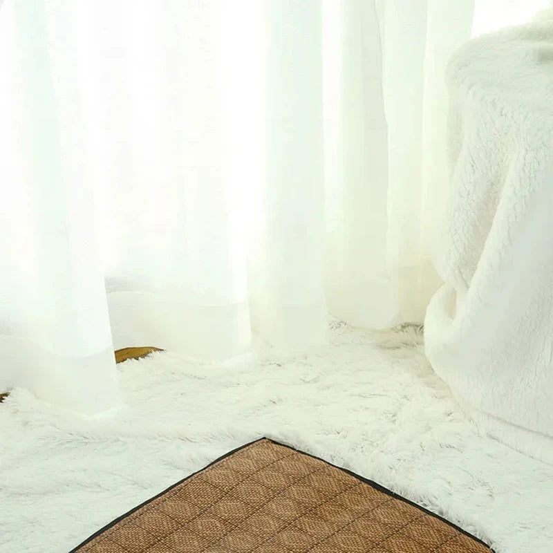 A fluffy white pet tent is visible on a light-colored rug with a brown mat.