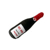 A black plush beer bottle dog toy with a red squeeze top and the words RED WINE and PRESTIGE printed on it.