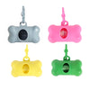 Three bone-shaped dog waste bag dispensers in gray, pink, and green with hanging loops.