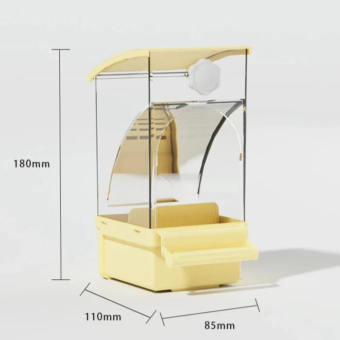A yellow automatic parrot feeder with a clear dome and a white dispensing mechanism.