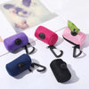 A collection of reusable dog poop bags in purple, pink, and black are displayed on a white surface.