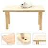 A white hamster is sitting on a wooden climbing platform designed for hamsters.