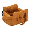A brown durable pet car seat with safety straps shown from the side.