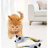 A small orange cat is interacting with a gray, mouse-shaped toy that has yellow feathers.