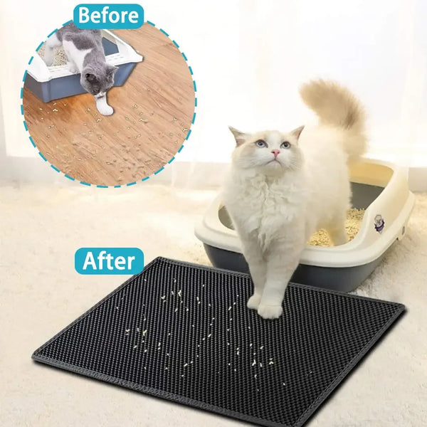 A white cat standing on a black double-layer cat litter mat placed in a gray litter box.