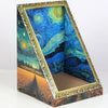 A wooden cat bed with a decorative frame and a colorful painted interior featuring a starry night sky landscape.