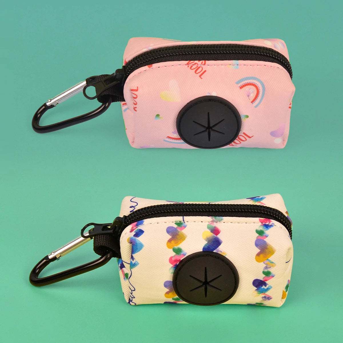 A pink zippered pouch with a black loop and a circular button is shown against a teal background.