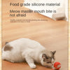A white cat is interacting with a red silicone ball toy for pets.