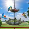 Antique umbrella bird feeder with a bath bowl suspended from a pole against a bright blue sky.