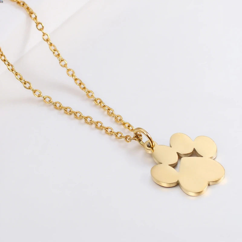 Gold stainless steel cat paw pendant necklace on a white background