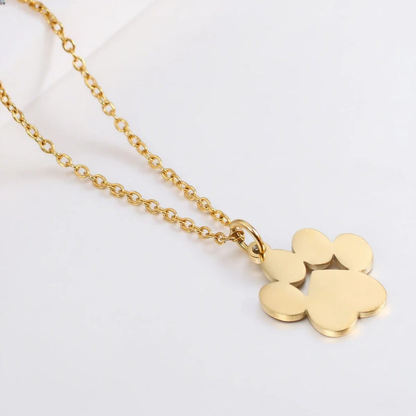 Gold stainless steel cat paw pendant necklace on a white background